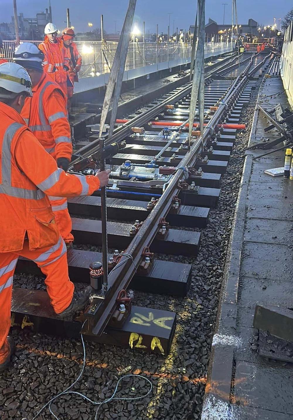 Cranes moving sections of a railway track